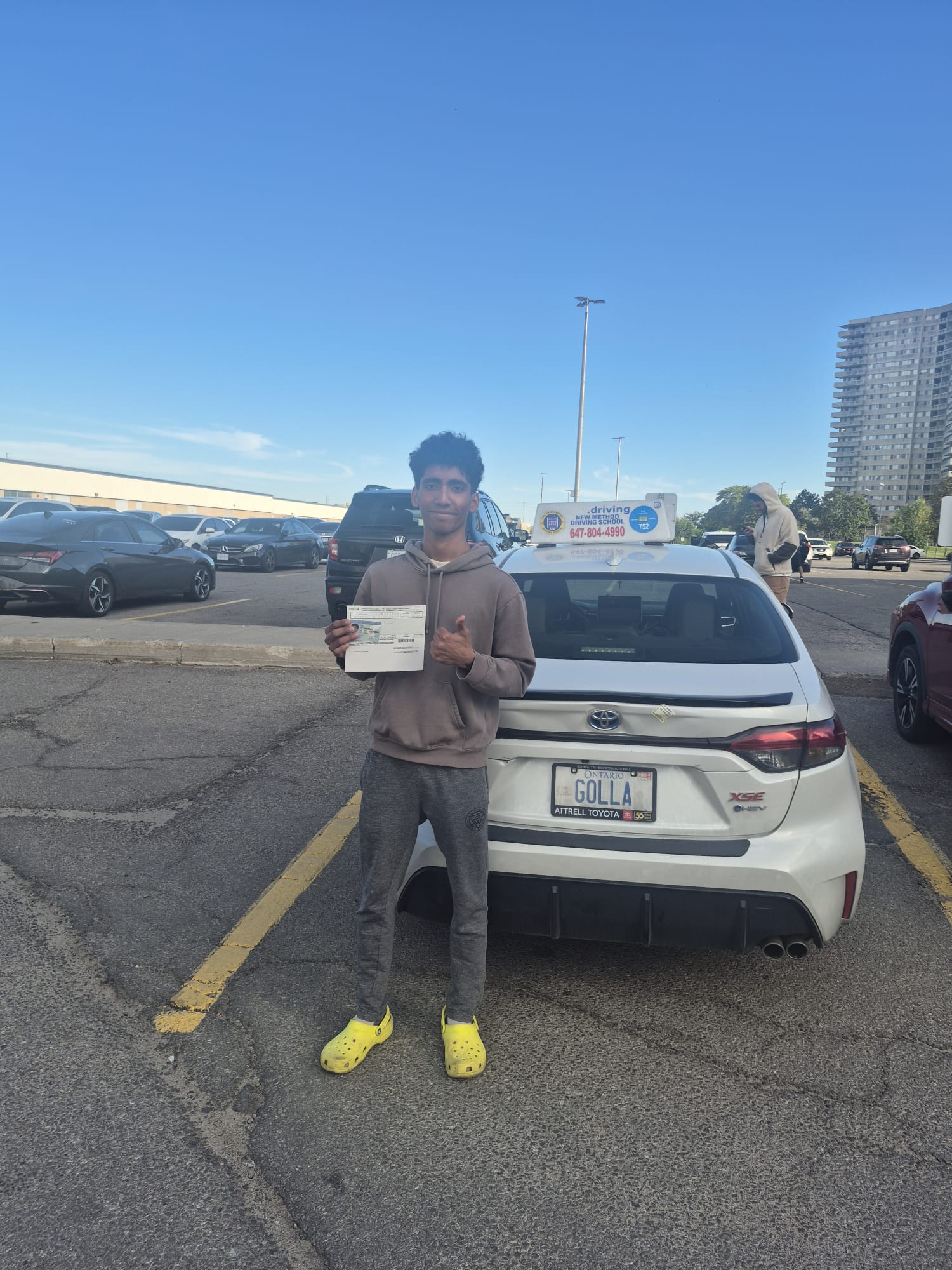 Student thumbs up after passing road test