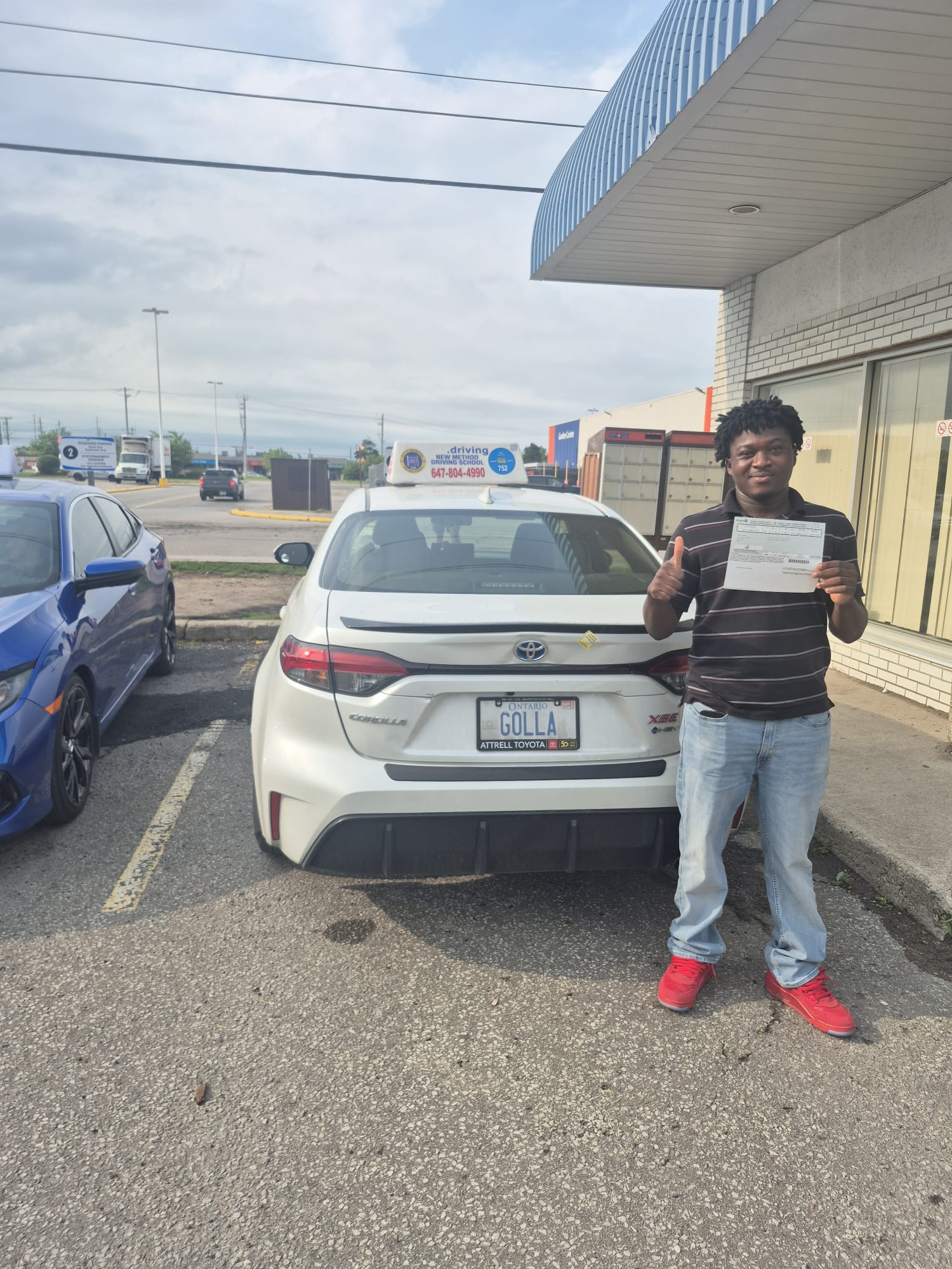 Student thumbs up by Corolla