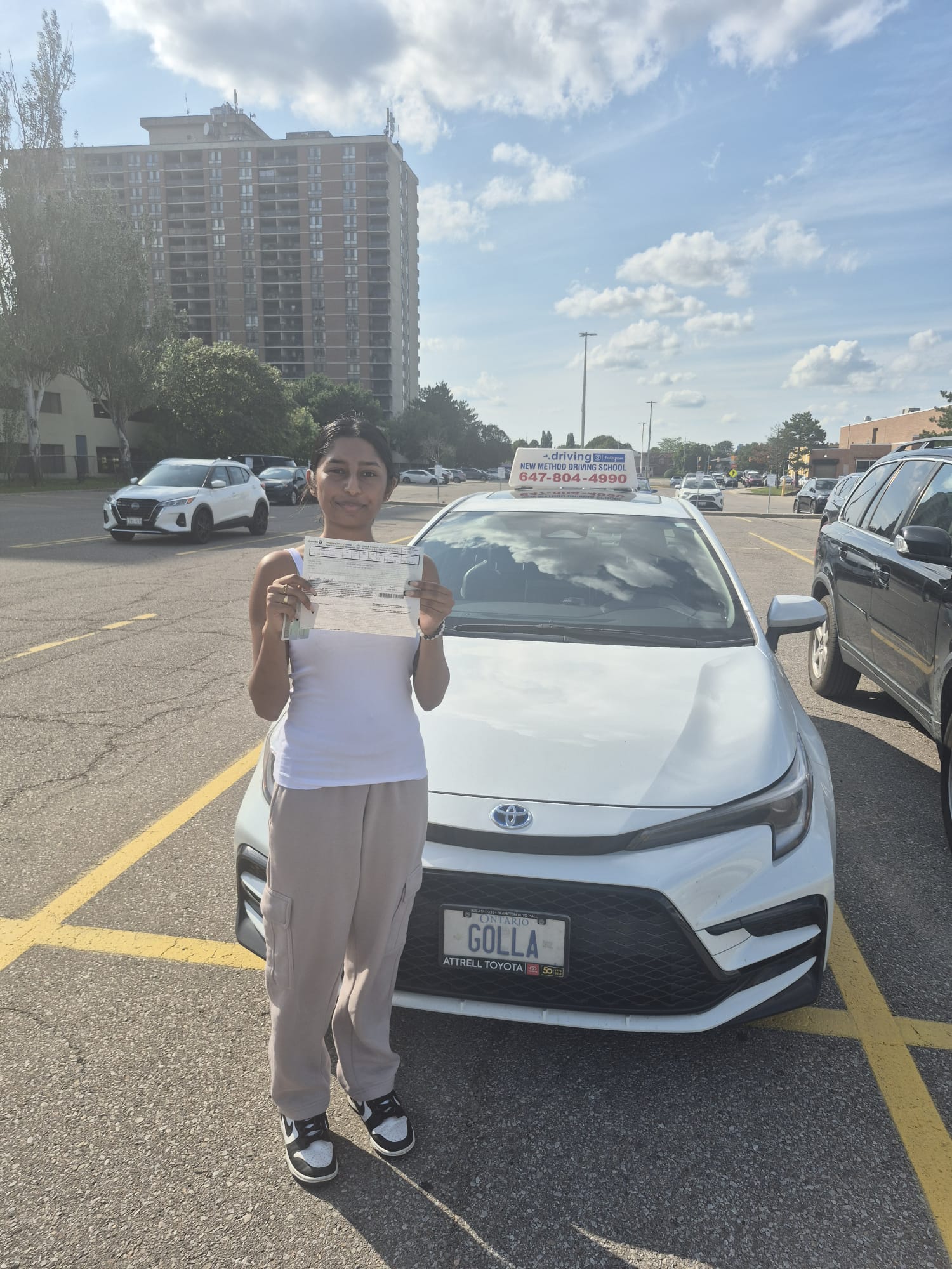 Student holding official driving pass